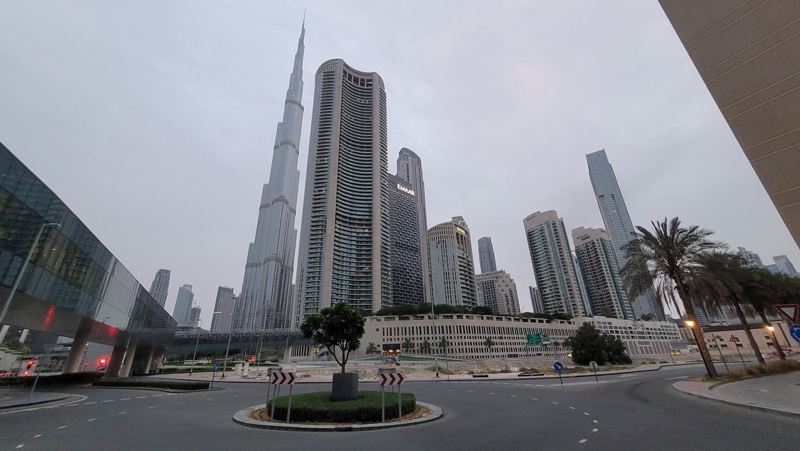 Burj Khalifa tower seen from street level near Dubai Mall, showing its full height above the surrounding skyline