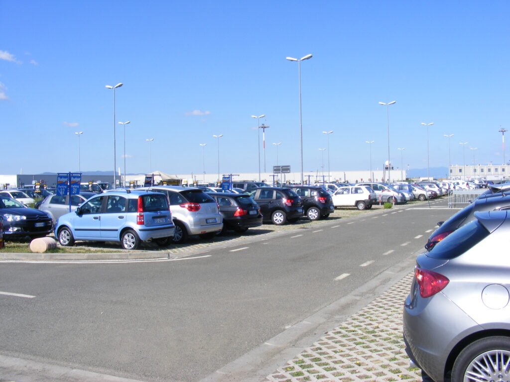Rows of rental cars parked at an airport rental car lot